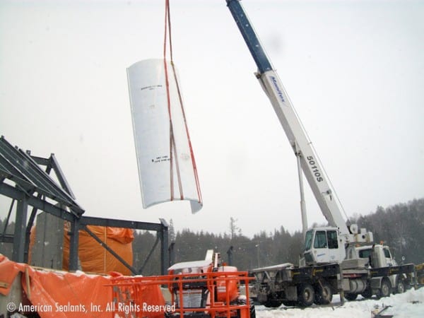 American Sealants Inc. building an aquarium in the snow with a large equipment
